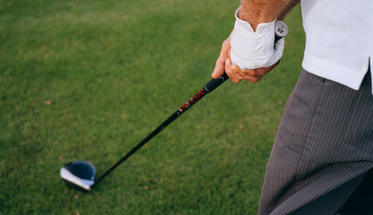 Close-up of a golfer's hands gripping a driver at address