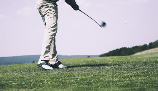 Golfer watching a drive after impact
