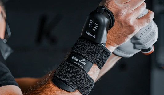 WhyGolf Wrist-X strapped to a golfer's lead wrist with the degree dial visible