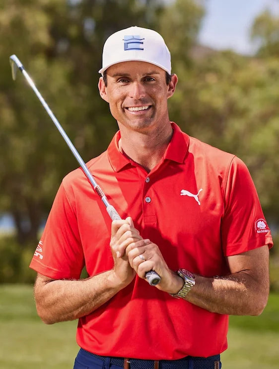 Chris Mayson smiling with a putter on the course